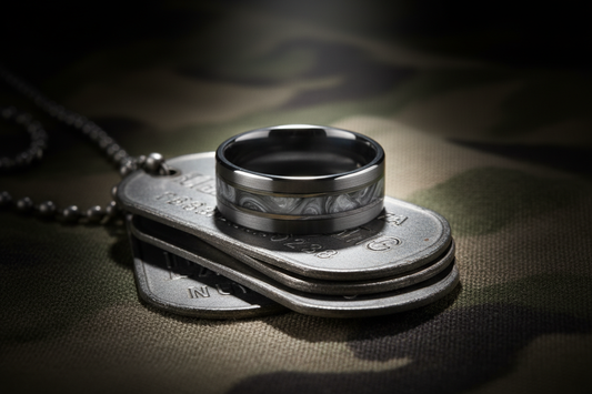 Handcrafted dark tungsten military dog memorial ring with ash inlay resting on military dog tags and camouflage fabric — WildBeard Legacy Co., Fort Collins, CO