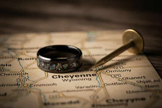 Handcrafted black ceramic memorial ring beside a Cheyenne Wyoming map pin — pet memorial jewelry for Cheyenne families, WildBeard Legacy Co.