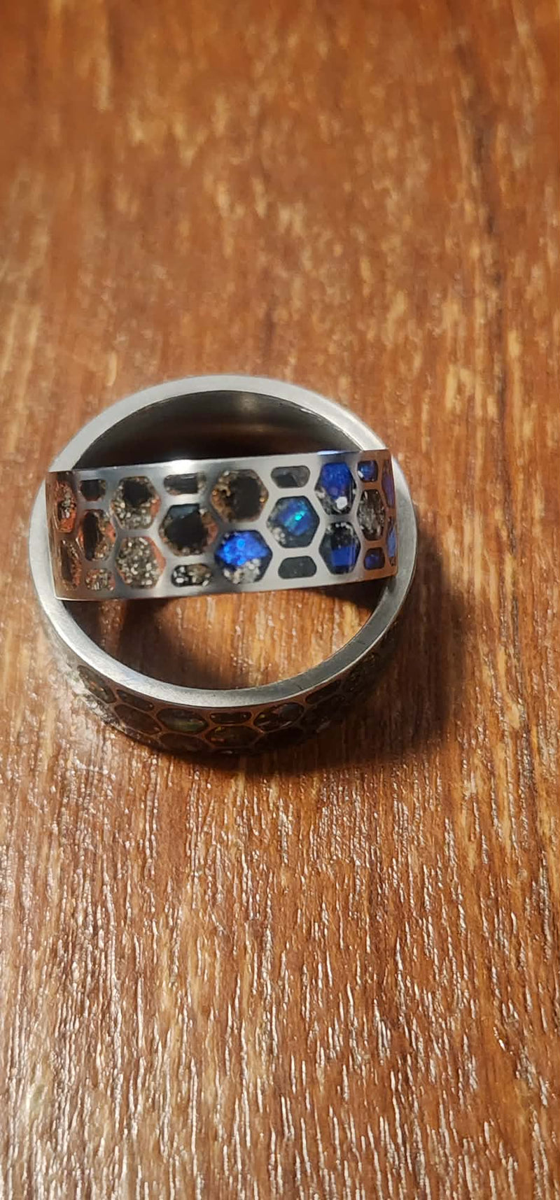 Titanium honeycomb band with memorial grandparents ashes inlayed with opal stones.