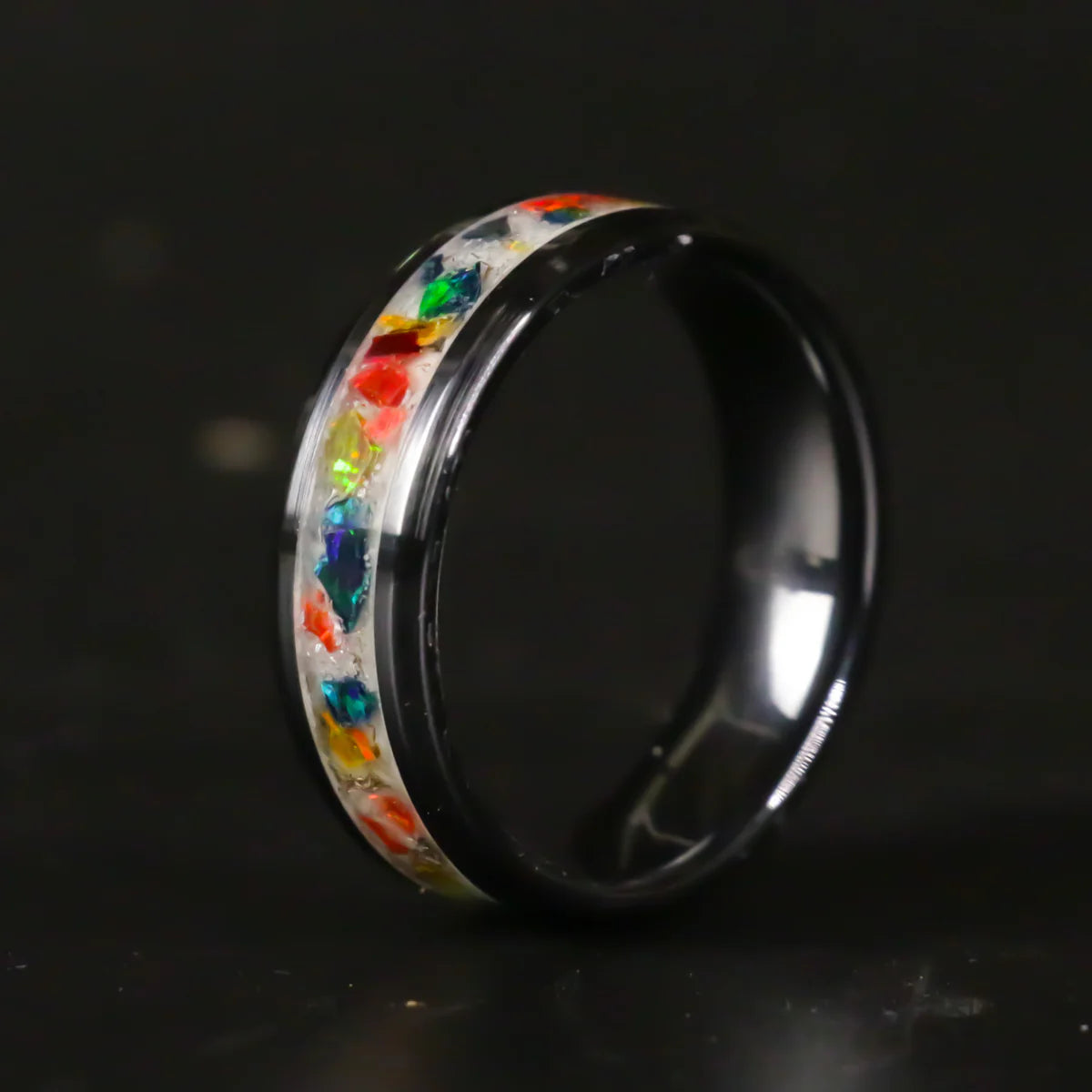  Tungsten Ring with colorful gemstones on a black background
