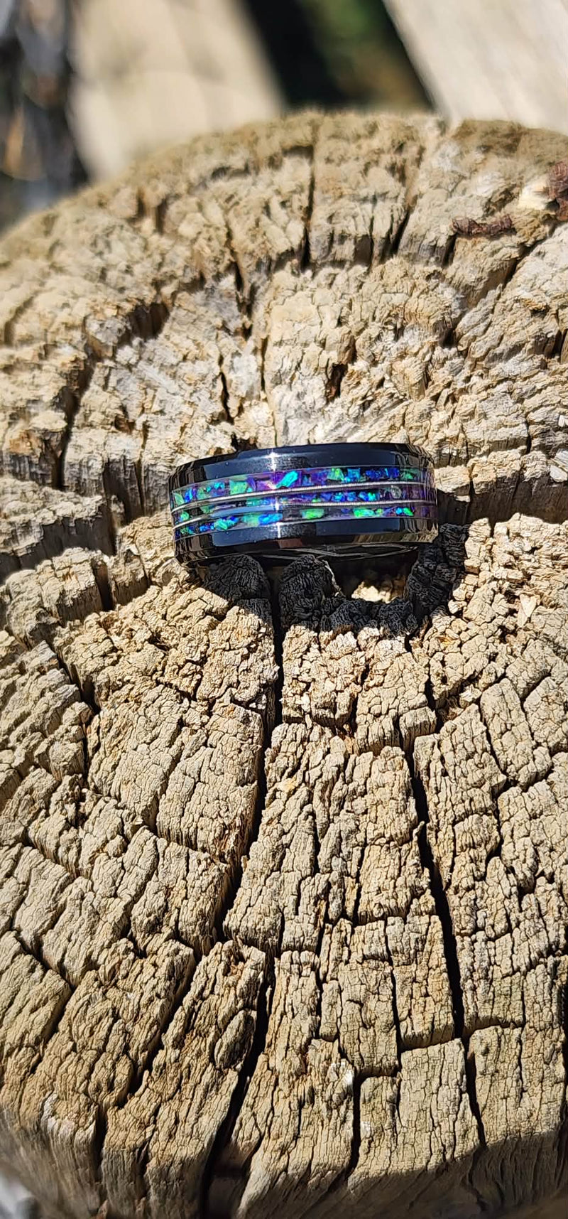 Black Ceramic wedding band with purple and green opals and guitar string inlay.