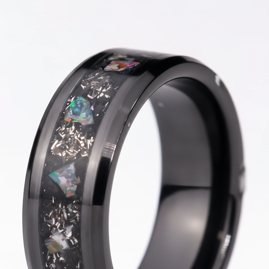 Close-up of Nebula Ash ceramic ring showing ash and opal inlay detail