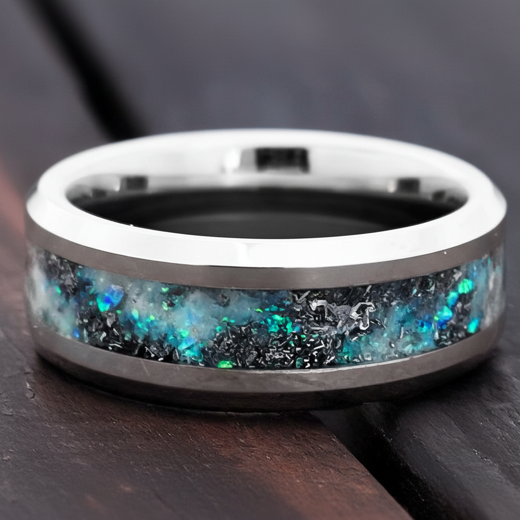 Silver ring with colorful stone on dark surface